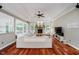Open living area with stone fireplace, tray ceiling, hardwood floors, and abundant natural light at 1125 Observatory Rd, Martinsville, IN 46151