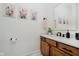 Charming powder room with wood cabinets, a stylish sink, and decorative wall art at 1125 Observatory Rd, Martinsville, IN 46151