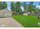 Spacious backyard featuring a well-maintained lawn, a detached garage and a fenced perimeter at 1149 E 56Th St, Indianapolis, IN 46220