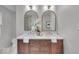 Charming bathroom with double sink vanity, decorative mirrors, and tiled walk-in shower at 1149 E 56Th St, Indianapolis, IN 46220