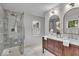 Updated bathroom with tile shower, double sinks with wood vanity, and modern fixtures at 1149 E 56Th St, Indianapolis, IN 46220