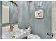 Charming half-bathroom with unique fixtures, gold accents, and blue colored walls at 1149 E 56Th St, Indianapolis, IN 46220