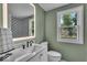 Elegant bathroom with marble vanity, decorative tile, and a view to the backyard at 1149 E 56Th St, Indianapolis, IN 46220