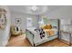 Cozy bedroom features a decorative mirror, bright windows, and hardwood floors at 1149 E 56Th St, Indianapolis, IN 46220