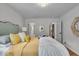 Bright bedroom with a decorative mirror, hardwood floors, and access to walk-in closet at 1149 E 56Th St, Indianapolis, IN 46220