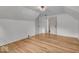 Bright bedroom featuring wood floors, a cozy light fixture, and built-in storage at 1149 E 56Th St, Indianapolis, IN 46220