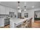 Spacious eat-in kitchen with stone backsplash, stainless steel appliances, and wooden floors at 1149 E 56Th St, Indianapolis, IN 46220