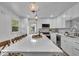 Bright kitchen features a large island with seating, stainless steel appliances, and modern lighting fixtures at 1149 E 56Th St, Indianapolis, IN 46220