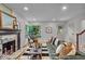 Cozy living room featuring hardwood floors, a fireplace, and stylish modern decor at 1149 E 56Th St, Indianapolis, IN 46220