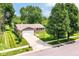 Aerial view of a home with well-kept lawn, a two-car garage, and mature trees at 12020 Colbarn Dr, Fishers, IN 46038