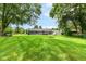 Beautiful back yard featuring large, lush lawn, mature trees, and a charming fire pit area at 12020 Colbarn Dr, Fishers, IN 46038