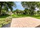 Expansive backyard featuring a brick patio and lush green lawn and mature trees at 12020 Colbarn Dr, Fishers, IN 46038