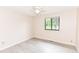 Bright spare bedroom with one window looking out onto the front yard and neutral walls at 12020 Colbarn Dr, Fishers, IN 46038