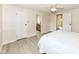 Bright bedroom with light wood flooring, fresh paint, and a ceiling fan fixture at 12020 Colbarn Dr, Fishers, IN 46038
