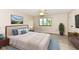 A well-lit bedroom with neutral walls, a large bed, and a blue rug at 12020 Colbarn Dr, Fishers, IN 46038