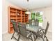 Dining area features a glass table, four chairs, and a bookshelf with a sliding glass door at 12020 Colbarn Dr, Fishers, IN 46038