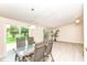 The dining room features a glass-topped table and four chairs, and a sliding glass door to the backyard at 12020 Colbarn Dr, Fishers, IN 46038