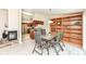 Bright dining room with a glass top table and an open view into a modern kitchen at 12020 Colbarn Dr, Fishers, IN 46038