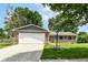 Charming brick home with a two-car garage, green lawn, and mature trees at 12020 Colbarn Dr, Fishers, IN 46038