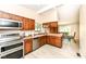 Kitchen features stainless steel appliances, wood cabinets, and a view to the dining room at 12020 Colbarn Dr, Fishers, IN 46038