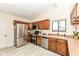 Kitchen with stainless steel appliances, wooden cabinets, and light countertops at 12020 Colbarn Dr, Fishers, IN 46038