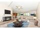 Bright living room with fireplace, comfortable seating, and view to dining area at 12020 Colbarn Dr, Fishers, IN 46038