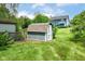 Backyard shed surrounded by a green lawn and trees with a blue house in the background at 12020 Colbarn Dr, Fishers, IN 46038