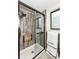 Shower with a wooden frame, glass door, detachable showerhead, and tile wall at 12020 Colbarn Dr, Fishers, IN 46038