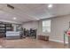 Unfinished basement area with neutral paint, drop ceiling, window, shelving and casual seating at 1225 Berrywood Dr, Greenwood, IN 46143