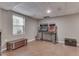 Unfinished basement area featuring neutral paint, drop ceiling, and vintage arcade games at 1225 Berrywood Dr, Greenwood, IN 46143
