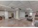 Neutral painted unfinished basement area with drop ceiling, recessed lights, and multiple entrances at 1225 Berrywood Dr, Greenwood, IN 46143