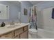 Bathroom with a single sink vanity, a shower over bath, and light blue walls at 1225 Berrywood Dr, Greenwood, IN 46143