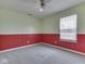 Bedroom with a window, gray carpet, and red and green wainscoting at 1225 Berrywood Dr, Greenwood, IN 46143
