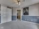 Bedroom with a closet, gray carpet, and blue and gray wainscoting at 1225 Berrywood Dr, Greenwood, IN 46143