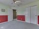 Bedroom with a closet, gray carpet, and red and green wainscoting at 1225 Berrywood Dr, Greenwood, IN 46143