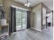 Bright dining area with sliding glass door to the backyard patio, fireplace, and gray wood-look floors at 1225 Berrywood Dr, Greenwood, IN 46143