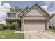 Charming two-story home with a brick facade and attached two-car garage at 1225 Berrywood Dr, Greenwood, IN 46143