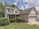 Charming two-story home with a brick facade and attached two-car garage at 1225 Berrywood Dr, Greenwood, IN 46143