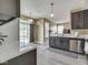 Modern kitchen featuring grey cabinets, stainless steel dishwasher, and bright countertops at 1225 Berrywood Dr, Greenwood, IN 46143