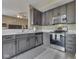 Stylish kitchen with stainless steel appliances, grey cabinets, and an open layout to the living space at 1225 Berrywood Dr, Greenwood, IN 46143