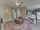 Inviting living room with a plush area rug, neutral walls, and open floor plan to the modern kitchen at 1225 Berrywood Dr, Greenwood, IN 46143