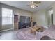 Comfortable living room with a colorful area rug, large entertainment center, and natural light from the window at 1225 Berrywood Dr, Greenwood, IN 46143