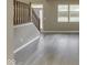 Open-concept living area showcasing stairs and stylish light-colored wood flooring at 1225 Berrywood Dr, Greenwood, IN 46143