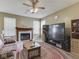 Cozy living room with a fireplace, ceiling fan and view of the decor at 1225 Berrywood Dr, Greenwood, IN 46143