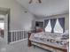 A well-lit main bedroom with a large bed, wood furniture, and a window at 1225 Berrywood Dr, Greenwood, IN 46143