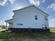 The back exterior reveals modern siding and a well-designed layout with clean lines and a brick foundation at 1256 Little Rodeo Pl, Greenwood, IN 46143
