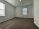 A spacious bedroom with neutral carpet and ample natural light from two windows at 1256 Little Rodeo Pl, Greenwood, IN 46143