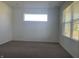 A serene bedroom with neutral carpet, bright windows, and a minimalist design at 1256 Little Rodeo Pl, Greenwood, IN 46143