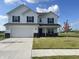 Charming two-story home showcasing a well-maintained lawn, a two-car garage, and a welcoming front porch at 1256 Little Rodeo Pl, Greenwood, IN 46143