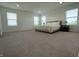 Large primary bedroom with ample natural light, neutral carpeting and two large windows at 1256 Little Rodeo Pl, Greenwood, IN 46143